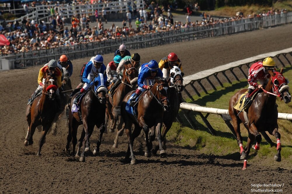 Horses ridden by jockeys compete at Hastings Park racecourse in Vancouver